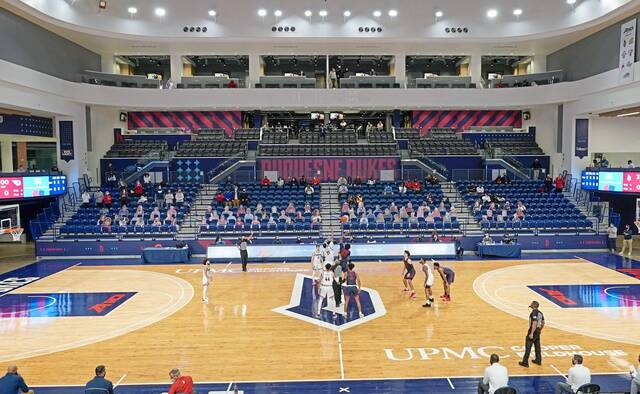 Players reach for the opening tip during a game between Duquesne and Dayton at Duquesne’s UPMC Cooper Fieldhouse on Tuesday, Feb. 2, 2021.