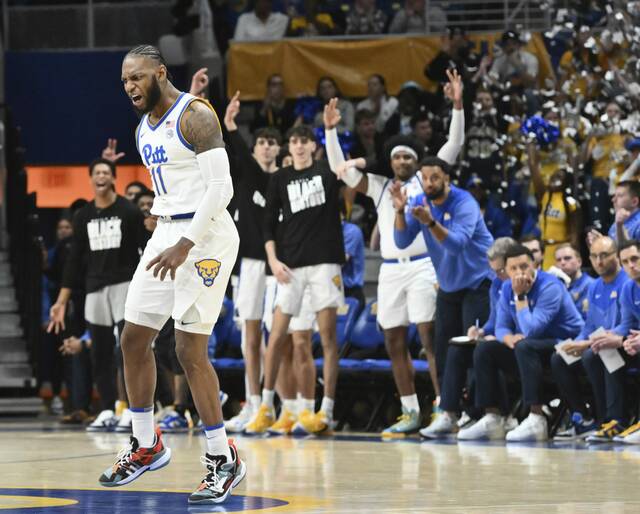 Pitt’s Jamarius Burton celebrates after hitting a 3-pointer against Syracuse to start the first half Feb. 25 at Petersen Events Center.