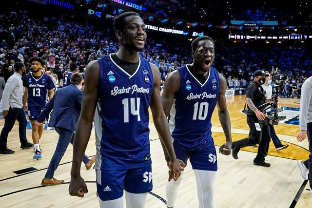 Saint Peter’s Hassan Drame, left, and Fousseyni Drame, right, celebrate after upsetting Purdue in the Sweet 16 in 2022.