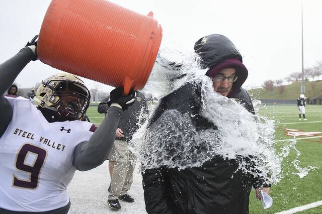 Steel Valley’s Todd Hill dumps the water cooler on head coach Rod Steele as time winds down in the WPIAL Class 2A championship game against South Side Beaver Saturday, Nov. 24, 2018, at Robert Morris Unversity.