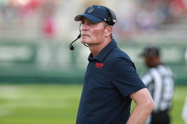 Duquesne coach Jerry Schmitt stand on the sideline before the team’s NCAA college football game against Hawaii on Saturday, Sept. 17, 2022, in Honolulu.