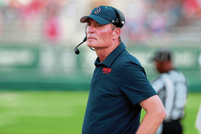 Duquesne coach Jerry Schmitt stand on the sideline before the team’s NCAA college football game against Hawaii on Saturday, Sept. 17, 2022, in Honolulu. (AP Photo/Marco Garcia)