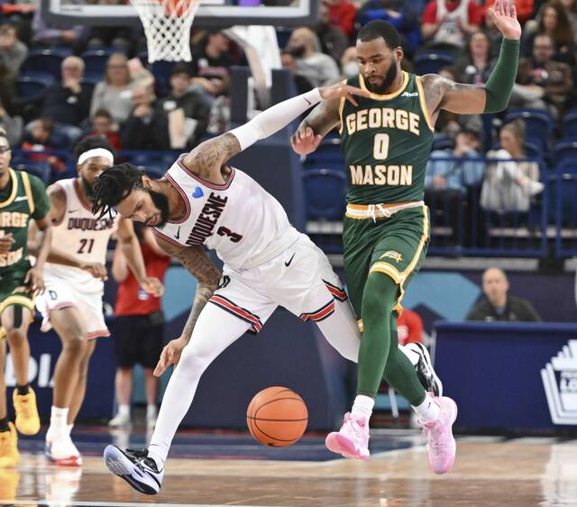 Duquesne’s Dae Dae Grant steals the ball from George Mason’s DeVon Cooper Wednesday, Feb. 2023 at UPMC Cooper Fieldhouse.