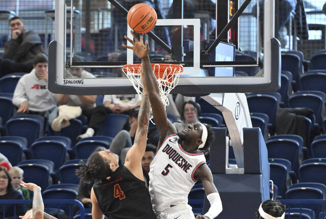 Duquesne’s Halil Barre blocks the shot of Winthrop’s Kelton Talford Dec. 21, 2022 at UPMC Cooper Fieldhouse.