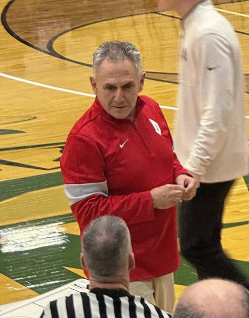 Duquesne coach Keith Dambrot talks to an official prior to the start of the Dukes’ game against Bradley on Monday in Akron, Ohio.