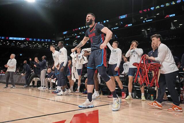 Duquesne forward Dusan Mahorcic reacts with teammates on the bench during the first half of their Atlantic 10 Tournament quarterfinal against Dayton on Thursday in New York.