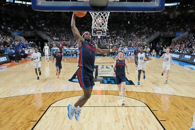 Duquesne guard Jimmy Clark III (1), wearing a new pair of shoes gifted by LeBron James, gets a basket against BYU in the second half of a first-round college basketball game in the NCAA Tournament, Thursday, March 21, 2024, in Omaha, Neb.