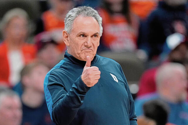 Duquesne coach Keith Dambrot signals to his team as they played against BYU in the first half of an NCAA Tournament game March 21 in Omaha, Neb.