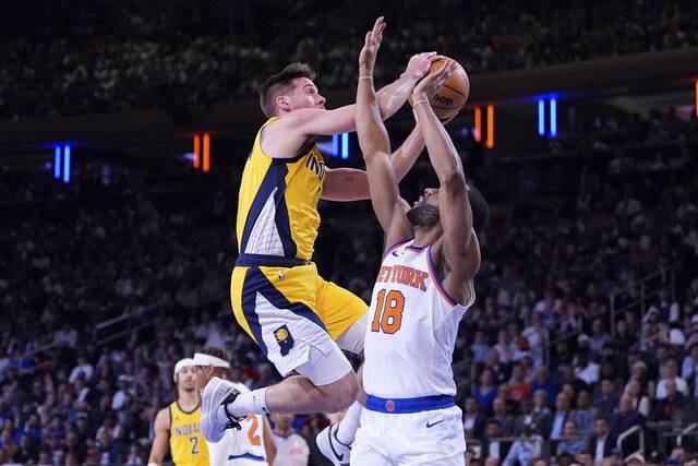 Indiana Pacers guard T.J. McConnell shoots past New York Knicks guard Alec Burks in their Game 7 Sunday in the second round of their NBA playoff series in New York.