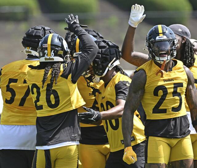 The Steelers defense celebrates with Beanie Bishop Jr. (30) after a breaking up a pass attempt during a seven shots drill Friday.