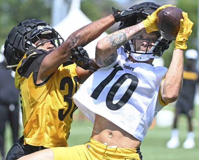 Pittsburgh Steelers receiver Roman Wilson pulls down a catch while Beanie Bishop defends during a training-camp practice earlier this summer at Saint Vincent College. Wilson was listed as questionable to play in Sunday’s game at the Denver Broncos.