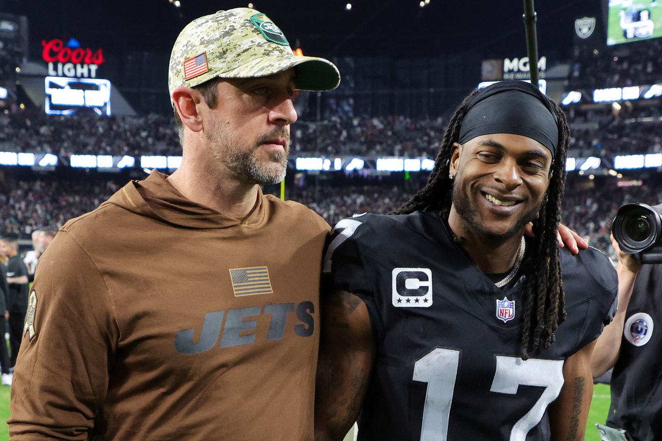 Quarterback Aaron Rodgers #8 of the New York Jets and wide receiver Davante Adams #17 of the Las Vegas Raiders visit on the field after the Raiders’ 16-12 victory over the Jets at Allegiant Stadium on November 12, 2023 in Las Vegas, Nevada.      