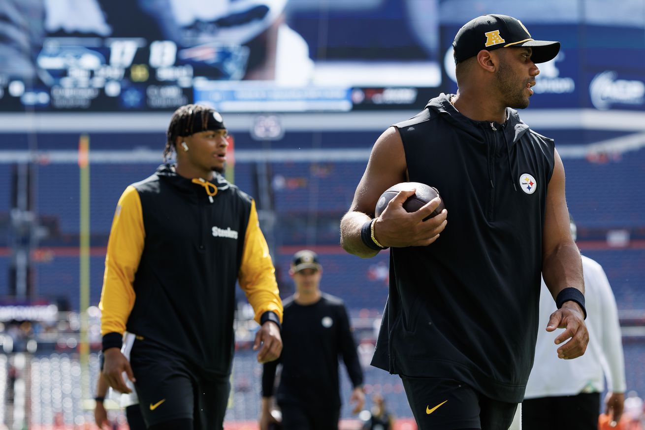 Quarterback Justin Fields #2 of the Pittsburgh Steelers and quarterback Russell Wilson #3 stand on the field prior to an NFL football game against the Denver Broncos, at Empower Field at Mile High on September 15, 2024 in Denver, Colorado.