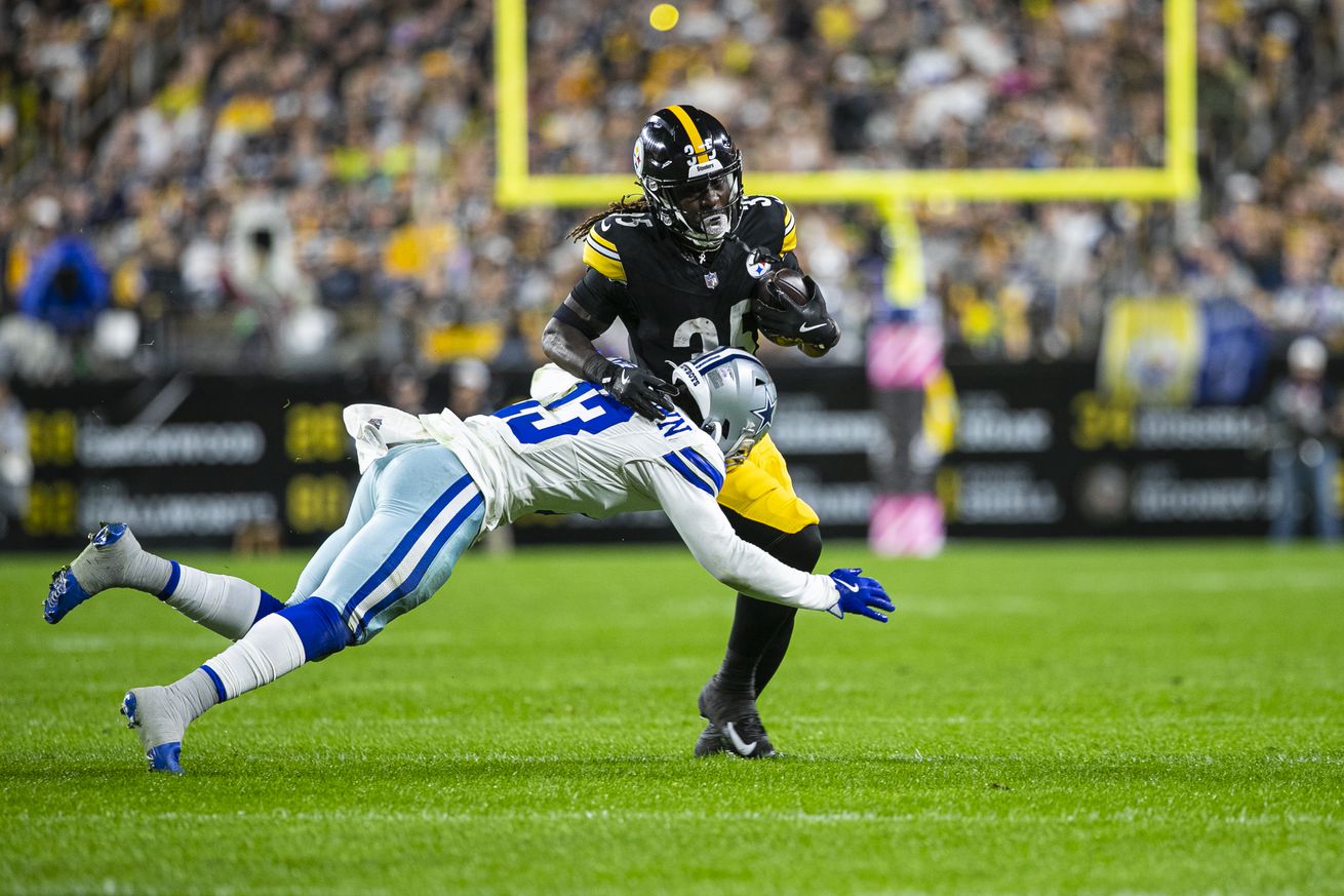 Pittsburgh Steelers running back Jonathan Ward (35) is tackled by Dallas Cowboys linebacker DeMarvion Overshown (13) during the regular season NFL football game between the Dallas Cowboys and Pittsburgh Steelers on October 06, 2024 at Acrisure Stadium in Pittsburgh, PA.