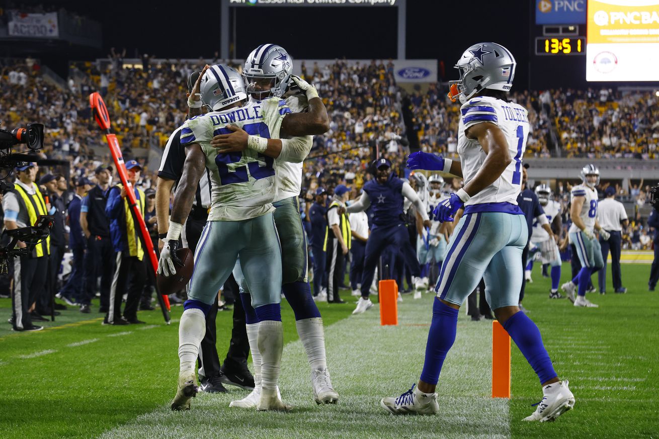 Rico Dowdle #23 of the Dallas Cowboys celebrates a touchdown with Dak Prescott #4 during the fourth quarter against the Pittsburgh Steelers at Acrisure Stadium on October 06, 2024 in Pittsburgh, Pennsylvania.