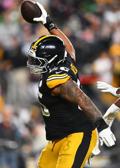 Dan Moore Jr. #65 of the Pittsburgh Steelers celebrates the touchdown of Russell Wilson #3 during the third quarter against the New York Jets at Acrisure Stadium on October 20, 2024 in Pittsburgh, Pennsylvania.