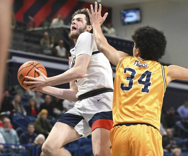 Duquesne’s Jake Dimichele scores past La Salle’s Tunde Vahlberg on Feb. 28, 2024 at UPMC Cooper Fieldhouse.