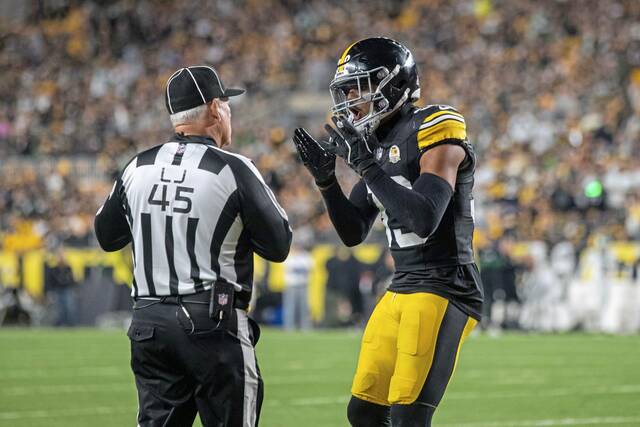 Steelers safety Minkah Fitzpatrick reacts Sunday with line judge Jeff Seeman during the game against the New York Jets in Pittsburgh.