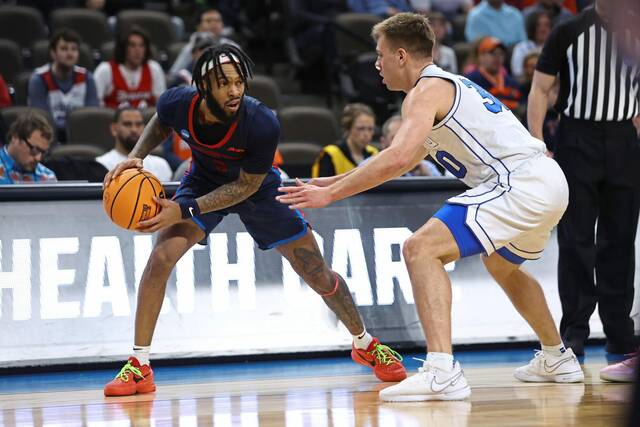 Duquesne guard Dae Dae Grant (3) is guarded by BYU guard Dallin Hall (30) in the first half of a first-round college basketball game in the NCAA Tournament, Thursday, March 21, 2024, in Omaha, Neb.