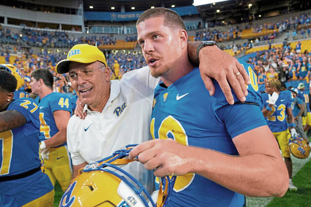 Pittsburgh head coach Pat Narduzzi, left, celebrates with quarterback Eli Holstein, right, after defeating West Virginia in an NCAA college football game, Saturday, Sept. 14, 2024, in Pittsburgh. (AP Photo/Matt Freed)