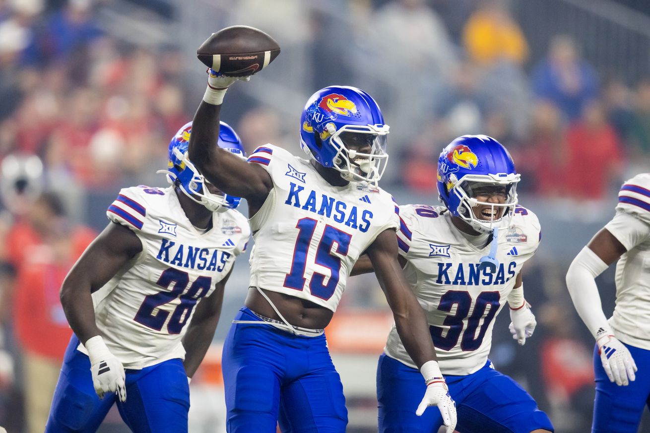 Kansas Jayhawks linebacker Craig Young (15) and Rich Miller Jr. (30) celebrate a play against the UNLV Rebels in the Guaranteed Rate Bowl at Chase Field. 