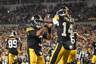 Pittsburgh Steelers wide receiver George Pickens (14) celebrates an 11 yard touchdown pass with quarterback Russell Wilson (3) iagainst the New York Jets during the second quarter at Acrisure Stadium. 