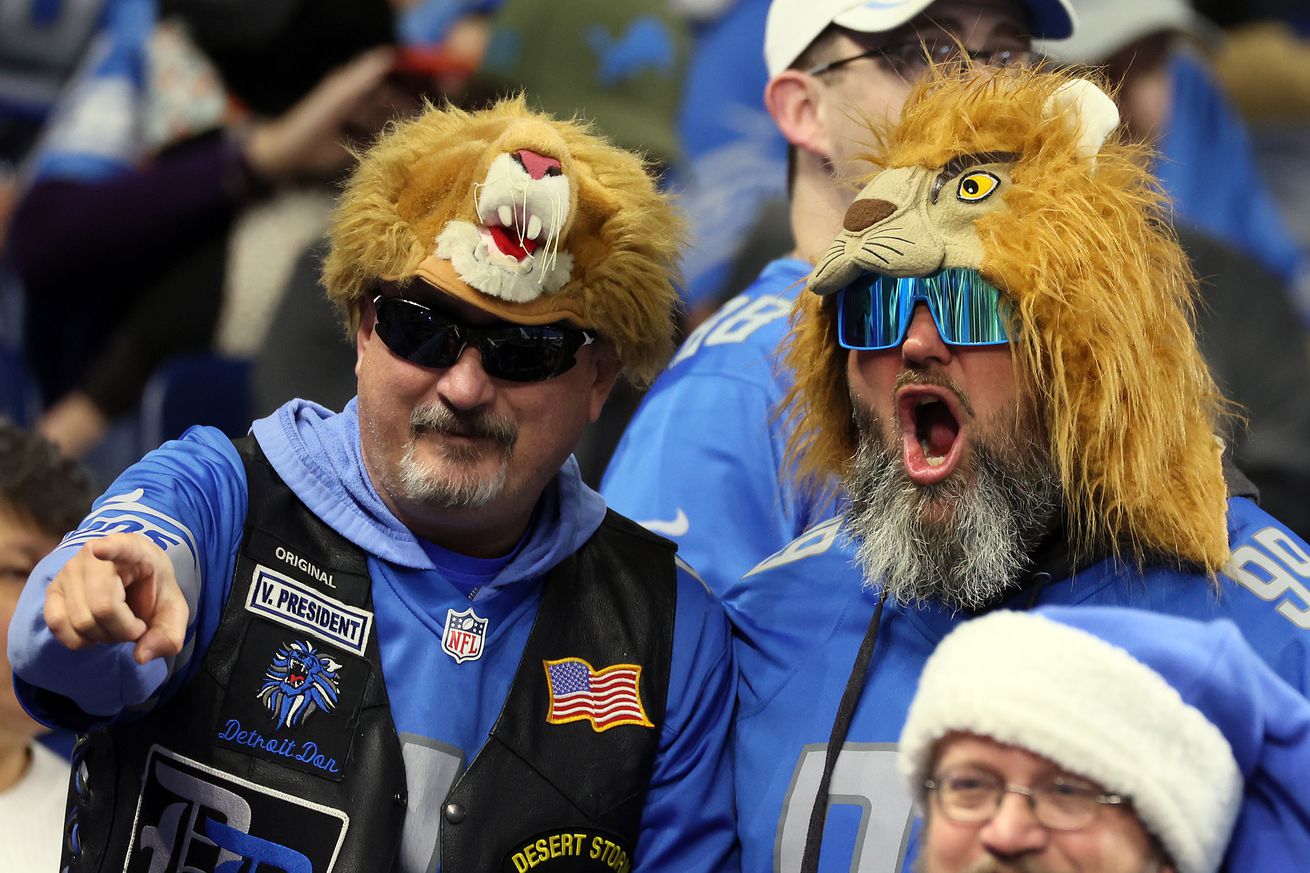  Fans in costume look on from the stands during an NFL football game between the Detroit Lions and the Chicago Bears in Detroit, Michigan USA, on Thursday, November 25, 2021.