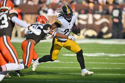 Safety Rodney McLeod Jr. #26 of the Cleveland Browns tackles running back Najee Harris #22 of the Pittsburgh Steelers during the second quarter at Cleveland Browns Stadium on November 19, 2023 in Cleveland, Ohio. The Browns defeated the Steelers 13-10.