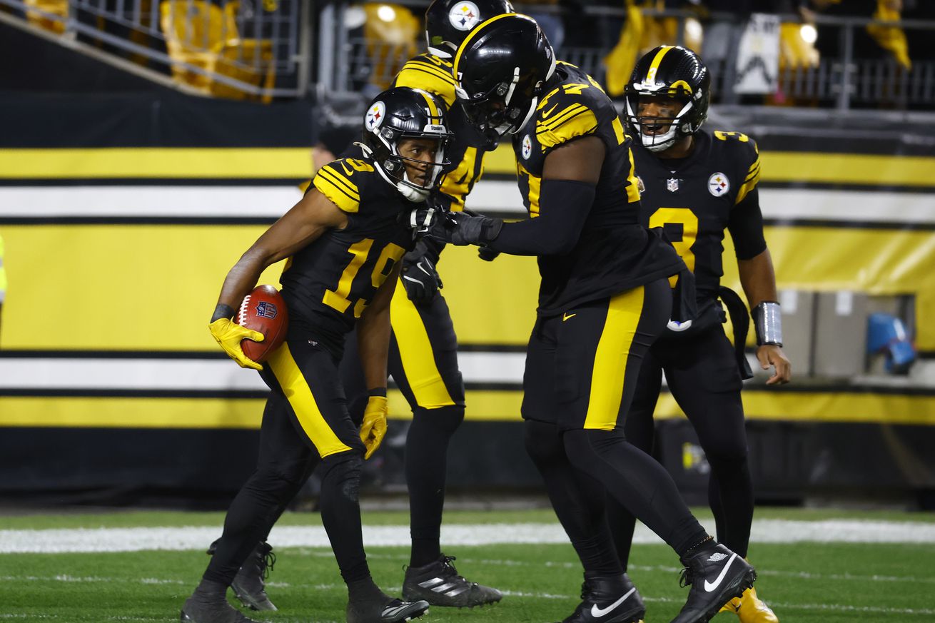 Calvin Austin III #19 of the Pittsburgh Steelers celebrates a touchdown with Broderick Jones #77 during the third quarter against the New York Giants at Acrisure Stadium on October 28, 2024 in Pittsburgh, Pennsylvania.