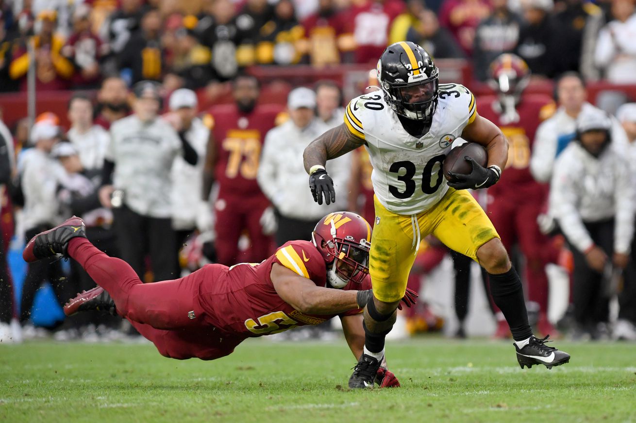 Steelers running back Jaylen Warren (30) runs through a tackle by Washington linebacker Bobby Wagner (54) during the Pittsburgh Steelers versus Washington Commanders National Football League game at Northwest Stadium on November 10, 2024 in Landover, MD.