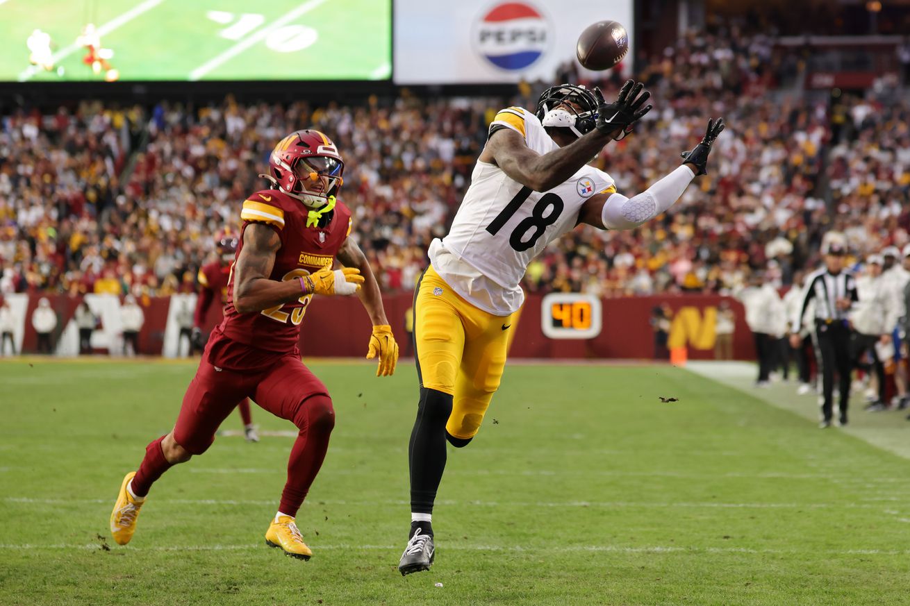 Mike Williams #18 of the Pittsburgh Steelers catches a go ahead touchdown against Benjamin St-Juste #25 of the Washington Commanders in the fourth quarter of a game at Northwest Stadium on November 10, 2024 in Landover, Maryland.