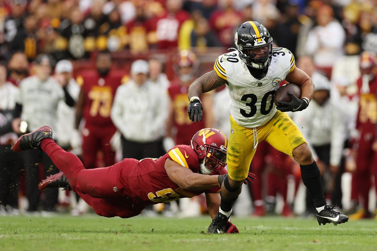 Jaylen Warren #30 of the Pittsburgh Steelers runs with the ball against the Washington Commanders during the fourth quarter at Northwest Stadium on November 10, 2024 in Landover, Maryland.