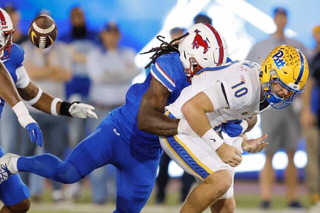 Pitt quarterback Eli Holstein fumbles as he is sacked by SMU defensive end Jahfari Harvey during the first half Saturday.