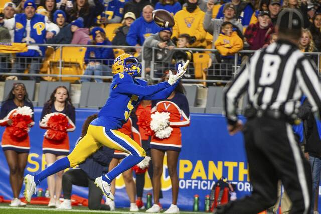 Pitt’s Raphael Williams Jr. attempts to secure a pass from Eli Holstein but comes up short against Virginia on Saturday, Nov. 9, 2024 at Acrisure Stadium.