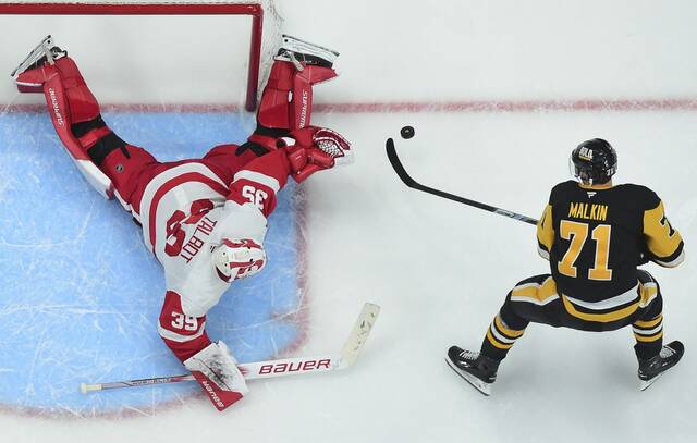 Red Wings goaltender Cam Talbot makes an overtime save on the Penguins’ Evgeni Malkin on Wednesday.