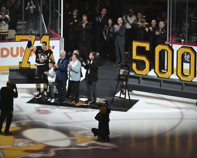 The Penguins celebrate Evgeni Malkin’s 500th goal with his family before a game against the Red Wings on Wednesday	at PPG Paints Arena.