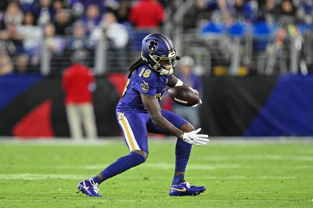 Ravens wide receiver Diontae Johnson looks for running room after a catch against the Bengals last week.