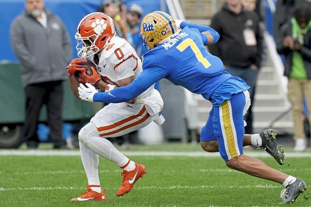 Clemson wide receiver Antonio Williams (0) catches a pass for a touchdown while being defended by Pitt defensive back Javon McIntyre (7) during the first half of an NCAA college football game Saturday, Nov. 16, 2024, in Pittsburgh.