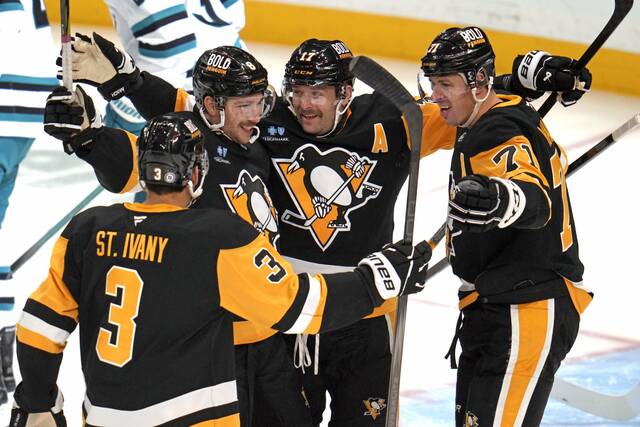 The Penguins’ Bryan Rust (second from right) celebrates his goal with Evgeni Malkin (71), Jack St. Ivany (3) and Michael Bunting during the first period Saturday.