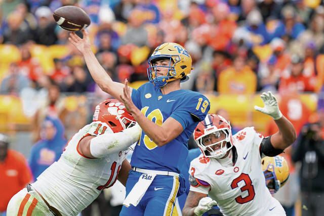 Pittsburgh quarterback Nate Yarnell (19) throws under pressure from Clemson defensive lineman Peter Woods (11) and defensive end T.J. Parker (3) during the second half of an NCAA college football game Saturday, Nov. 16, 2024, in Pittsburgh. (AP Photo/Matt Freed)