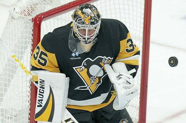 Pittsburgh Penguins goaltender Tristan Jarry (35) deflects a shot during the first period of an NHL hockey game against the New York Rangers, Wednesday, Oct. 9, 2024, in Pittsburgh.