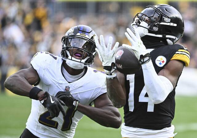 Steelers receiver George Pickens beats the Ravens’ Brandon Stephens in the third quarter Sunday.