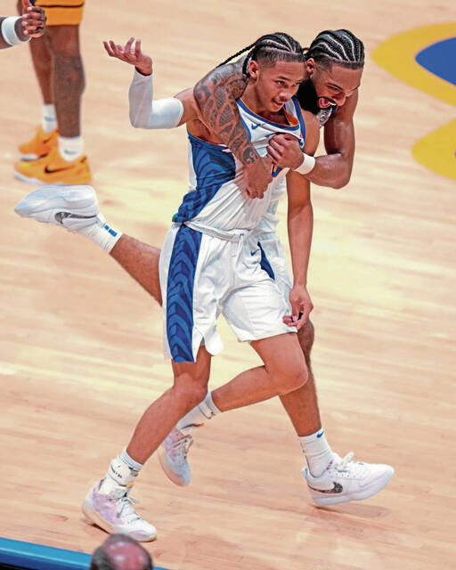 Pittsburgh ‘s Damian Dunn, rear, celebrates his basket with Jaland Lowe at the end of the first half of an NCAA college basketball game against West Virginia Friday, Nov. 15, 2024, in Pittsburgh. (AP Photo/Gene J. Puskar)