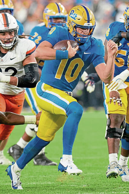 Pitt quarterback Eli Holstein scrambles during the first half against Virginia on Nov. 9.