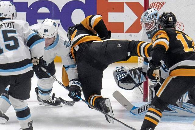 The Penguins’ Sidney Crosby is upended in front of Utah goaltender Karel Vejmelka in the first period Saturday.