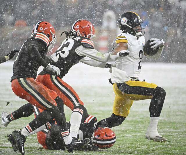 The Steelers’ Justin Fields is taken down for a loss by the Browns’ Devin Bush in the fourth quarter Thursday.