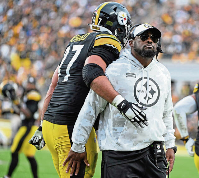 The Steelers’ Cameron Heyward celebrates with head coach Mike Tomlin after beating the Ravens 18-16 Sunday Nov. 17, 2024 at Acrisure Stadium.