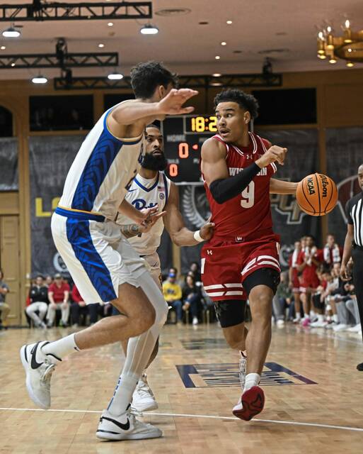 Wisconsin’s John Tonje (9) looks to pass during the first half of an NCAA college basketball game against Pittsburgh on Sunday Nov. 24, 2024, in White Sulphur Springs, W.Va. (AP Photo/Chris Jackson)