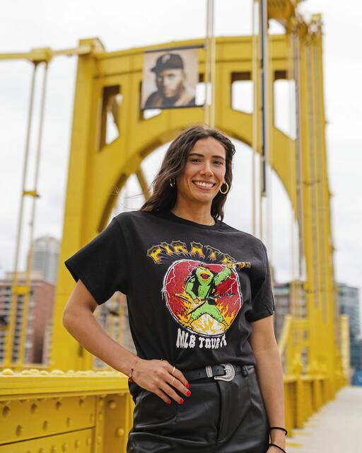 Pitt sixth-year volleyball player Valeria Vazquez Gomez poses in one of the Pittsburgh Pirates’ 2024 promotional T-shirts while standing at the Clemente Bridge. Vazquez Gomez hails from Puerto Rico.