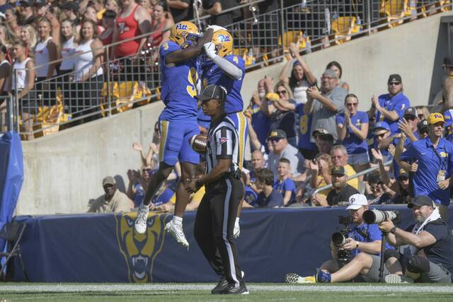 Pitt Konata Mumpfield and Daniel Carter celebrate in the end zone after a Carter touchdown in the first half against Youngstown State earlier this season.